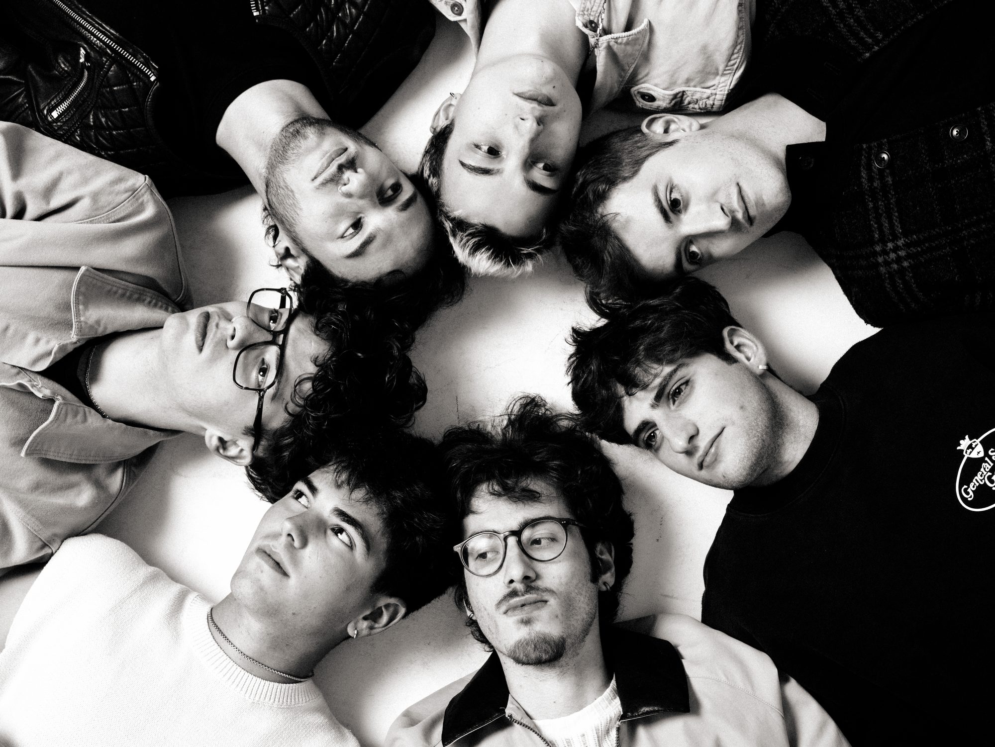 The band lying down with heads together, black and white
